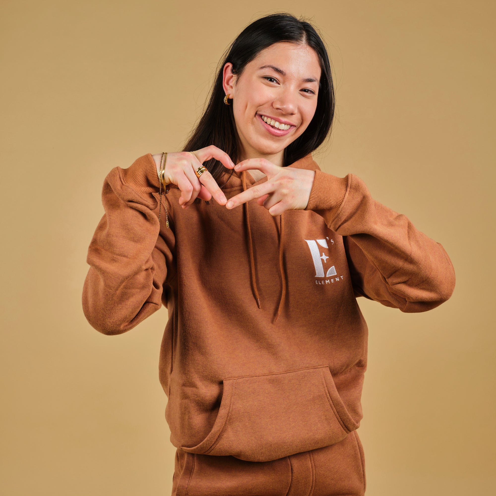 Cassie wearing the E’s Element Essential Sweatsuit Set in Brown Sugar 