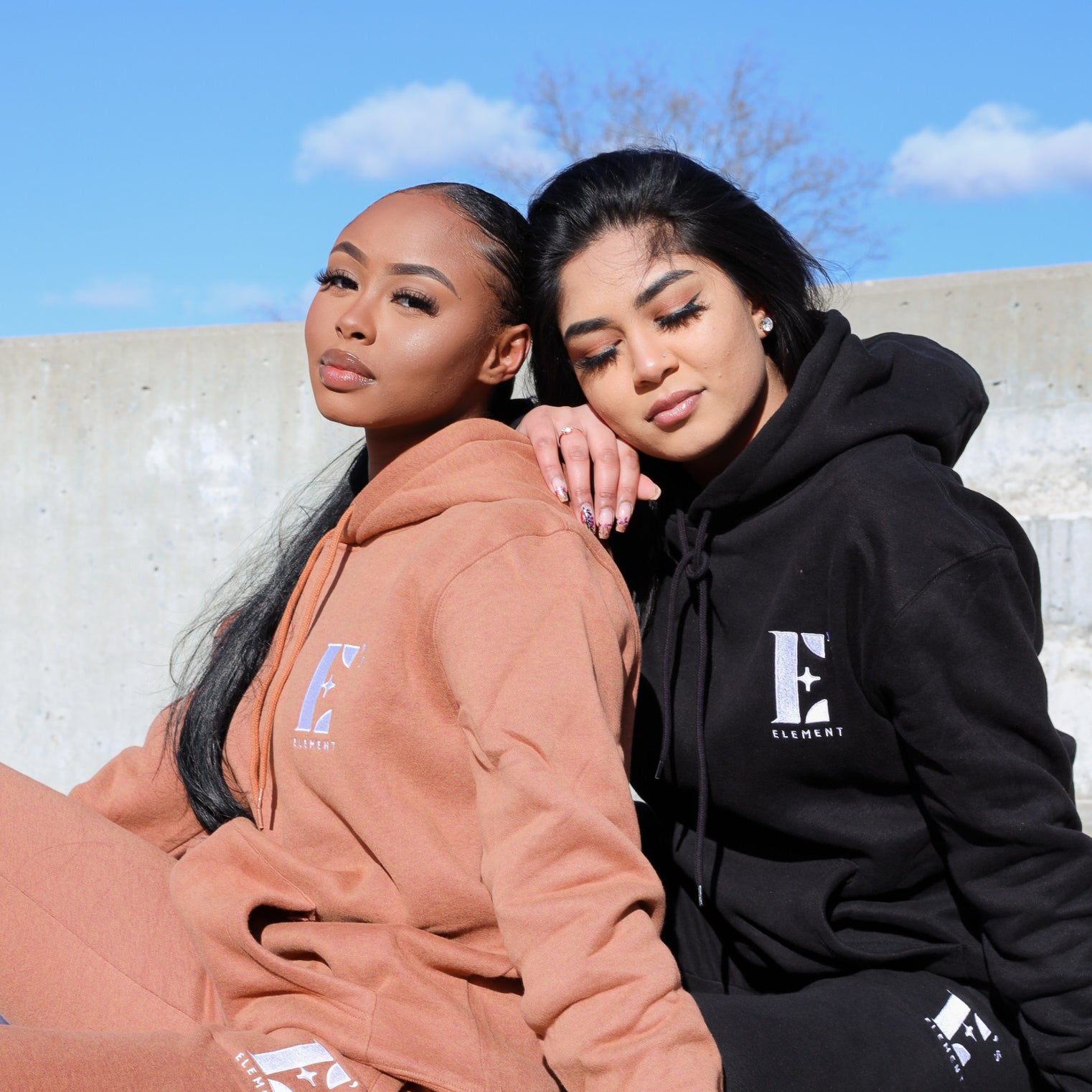 2 models in E's Element's Brown Sugar and Smoky Black sweat suit sets