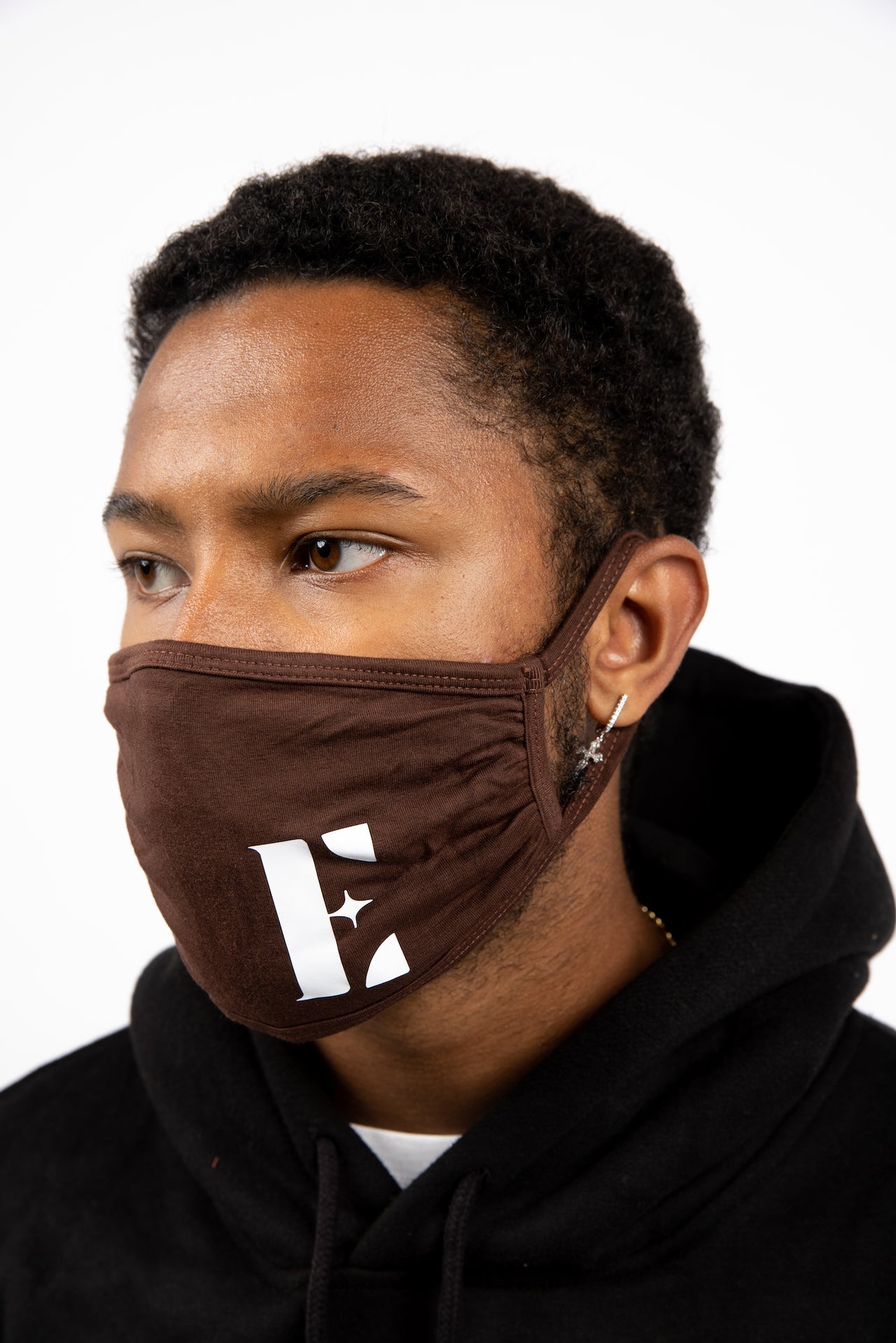 Man wearing E's Element reusable face mask in dark brown. The face mask is imprinted with the E's Element logo in white. Chocolate Face Mask by E's Element.