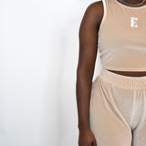 Model wearing beige tank top and shorts. The tank top has the E's Element logo imprinted in white in the middle. Ella Champagne Velvet Set by E's Element.