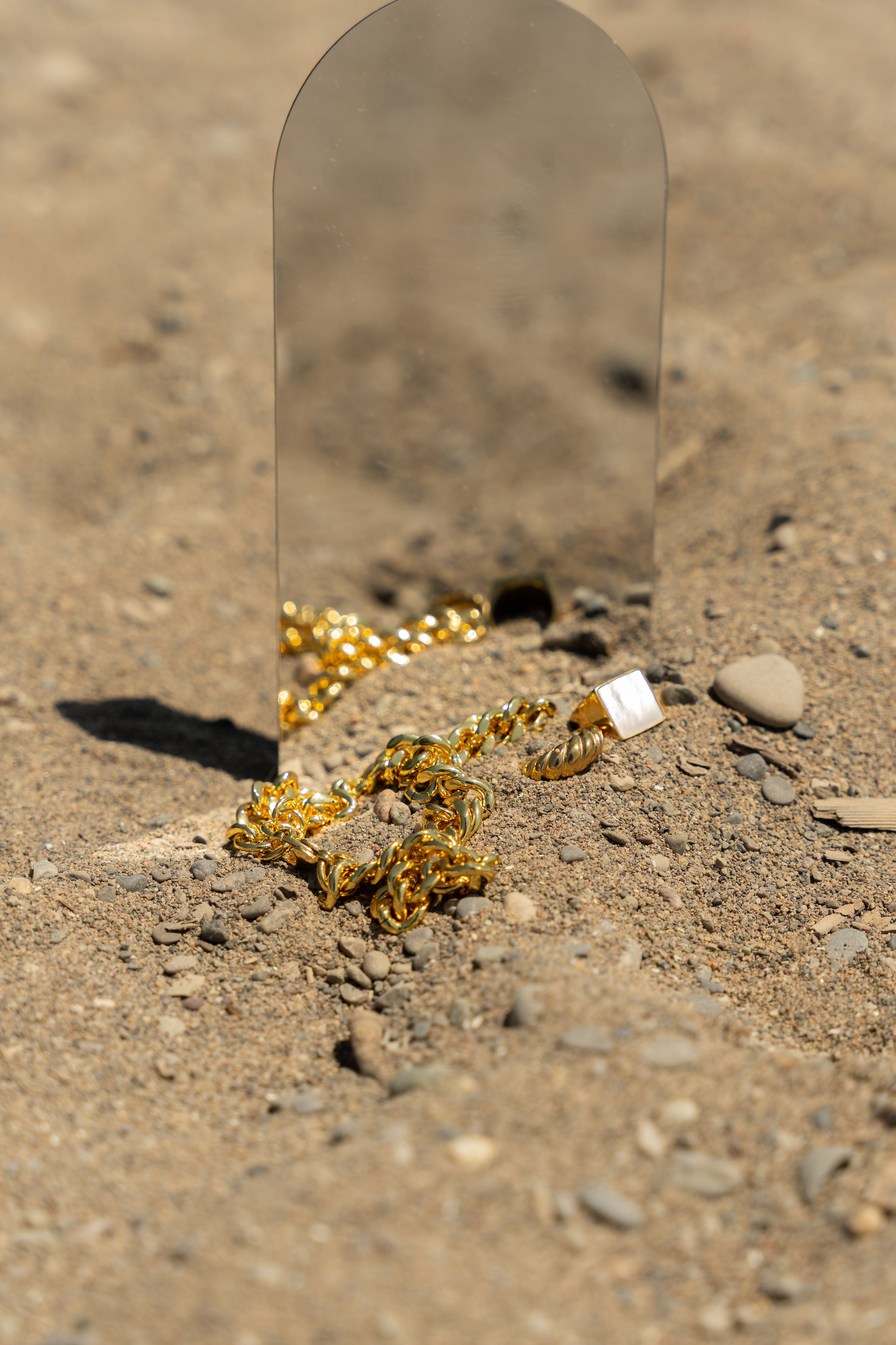 18k gold stainless steel bracelet and ring resting in front of a mirror. Build Your Own Signature Set by E's Element.