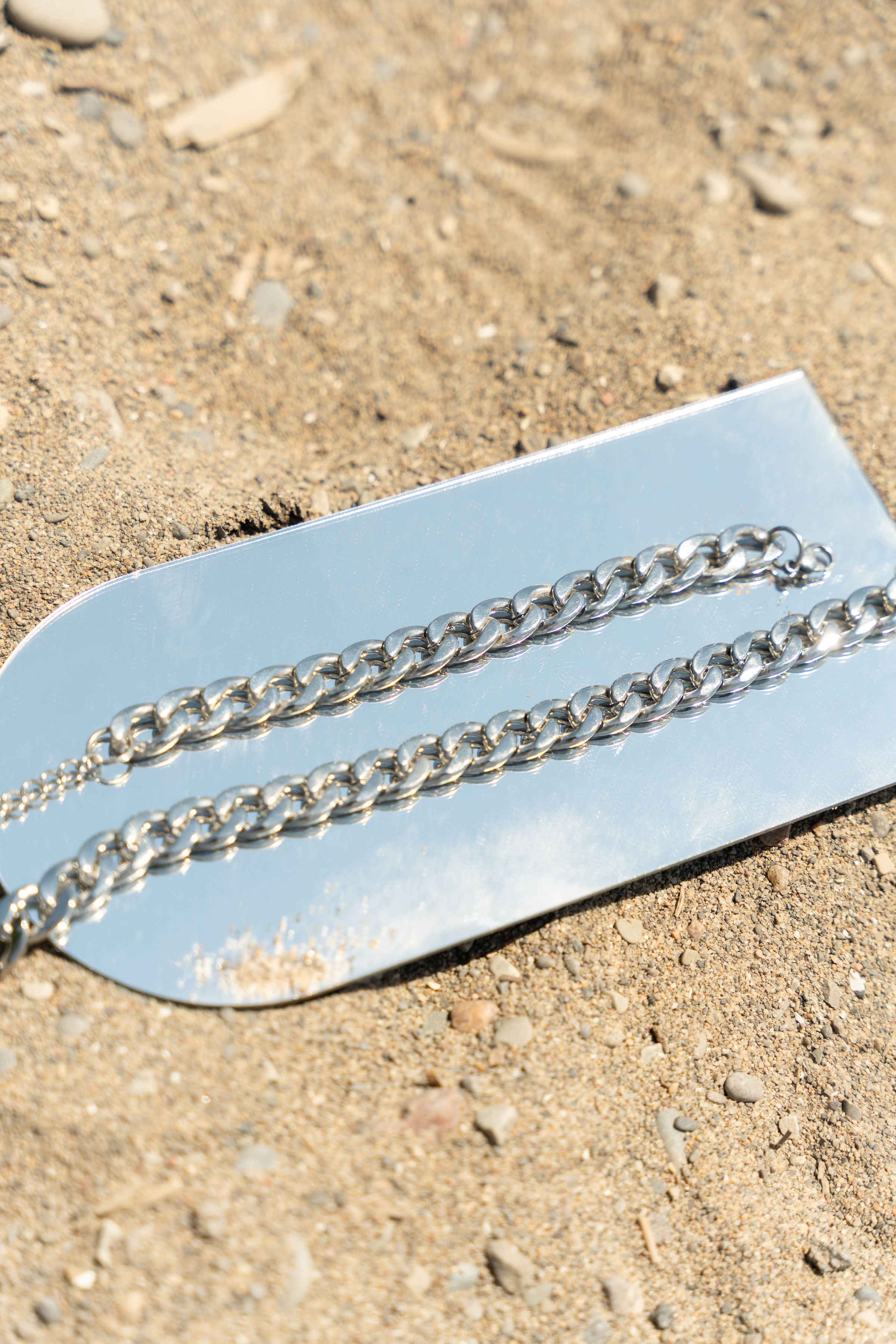 E's Element stainless steel chain necklace resting on top of a mirror. Build Your Own Silver Jewelry Set by E's Element.