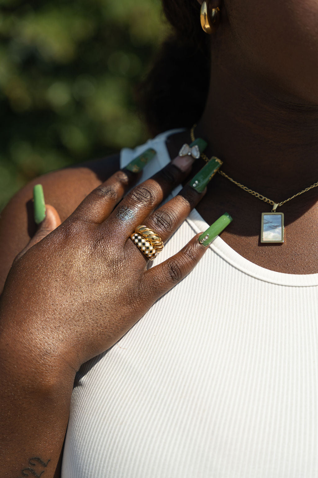 Model in a white top wearing an 18k gold ring with black and yellow diamond dots. Minimalist Resin Ring by E's Element.