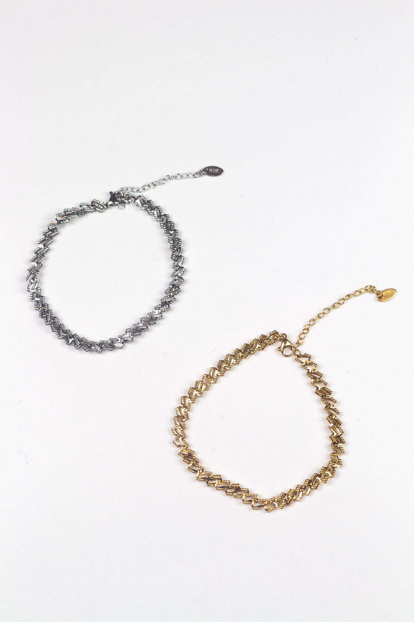 On the left is an 18k silver chain anklet. On the right is an 18k gold chain anklet. Ellina Link Chain Anklet by E's Element.