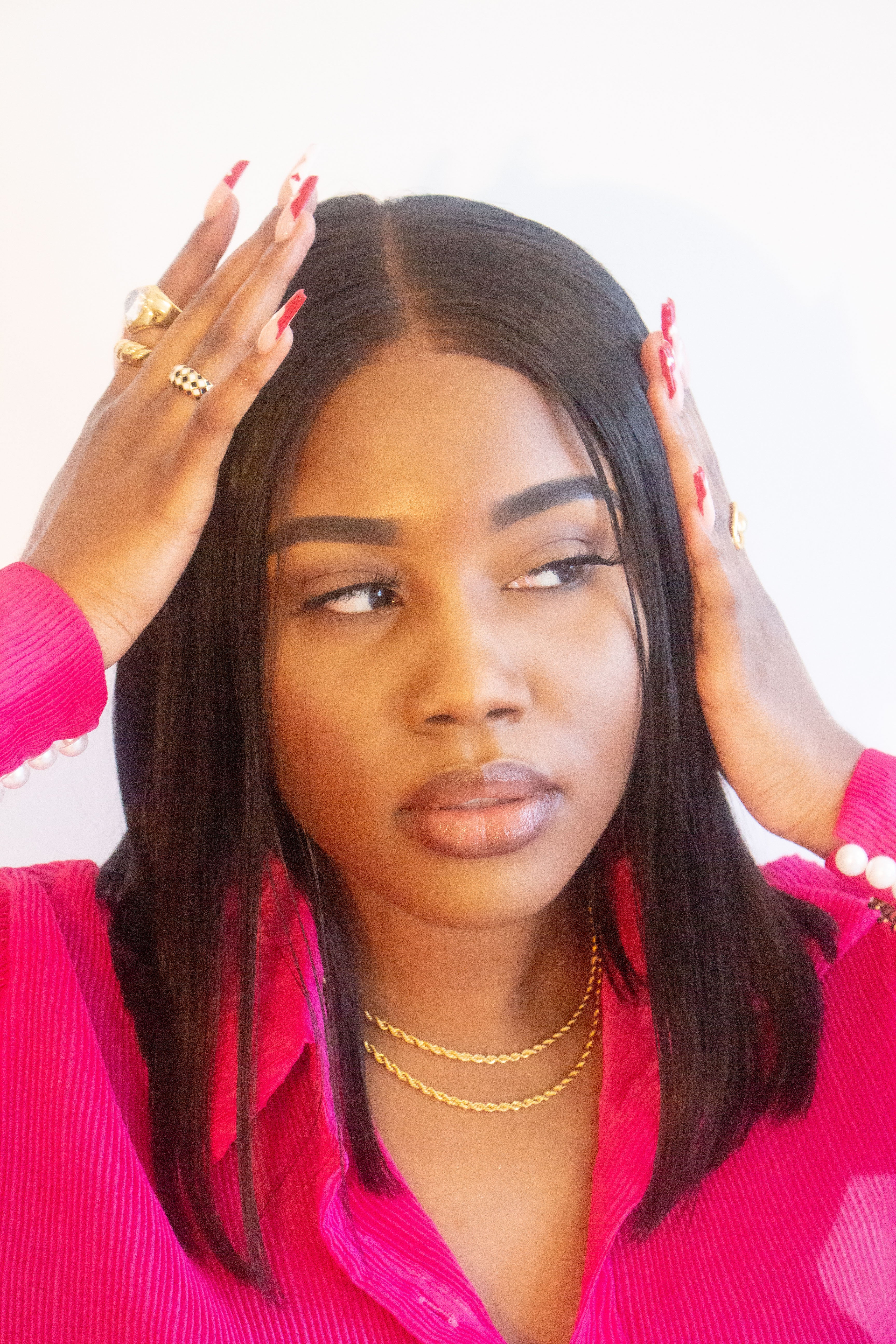 Woman in a pink top wearing two stainless steel twist chains. Named "The Toyo" Twist Chain 2.0 by E's Element.
