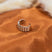 18k silver braided ring. The ring is placed on an orange cloth.  Platinum Double Band Ring by E's Element.
