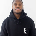 Model wearing a black hoodie. The hoodie has the E's Element logo imprinted in white. E's Element Essential Smoky Black Sweatsuit Set by E's Element.