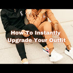 There are two models in this video. One of the models is wearing a light orange track suit and the other is wearing a black track suit. The hoodies and track pants have E's Element logo imprinted in white.