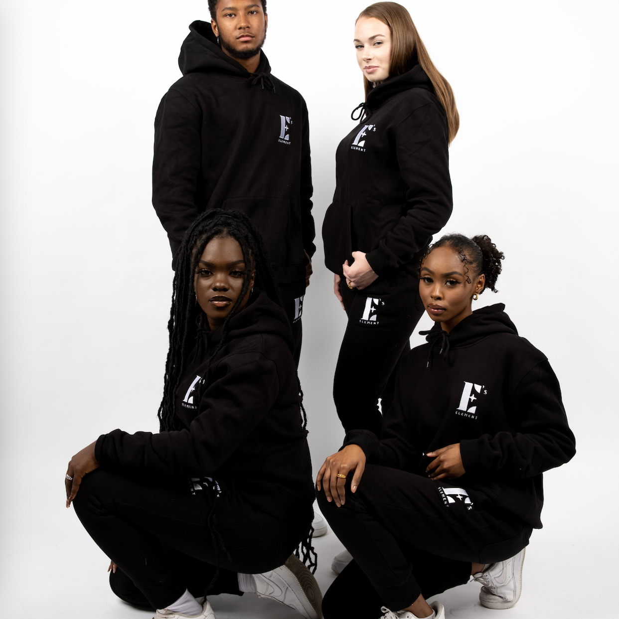 four models wearing E's Element Essential Sweatsuit Set in Black
