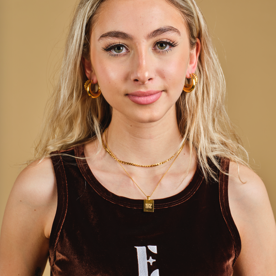 model wearing E's Element earrings and velvet two piece set 