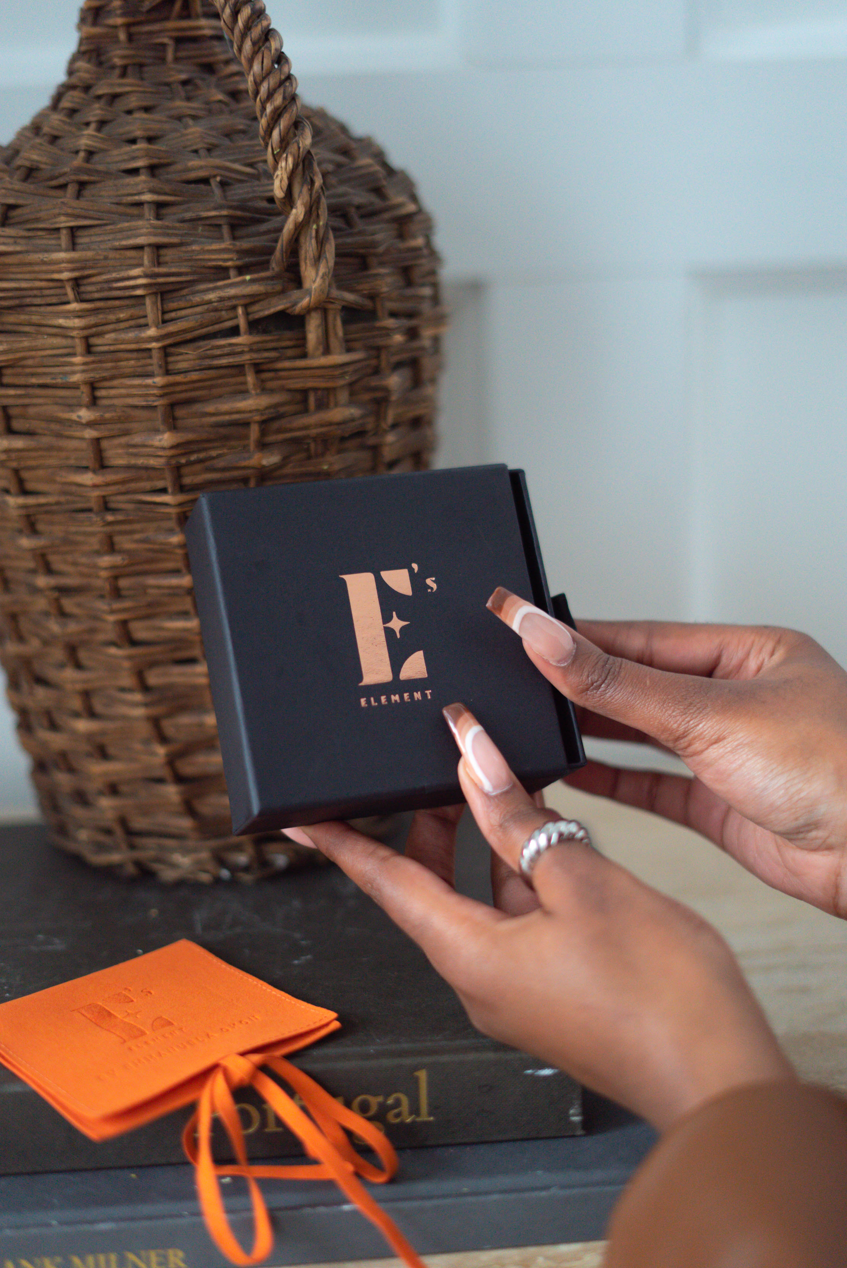 Hands holding an E's Element branded jewlery box