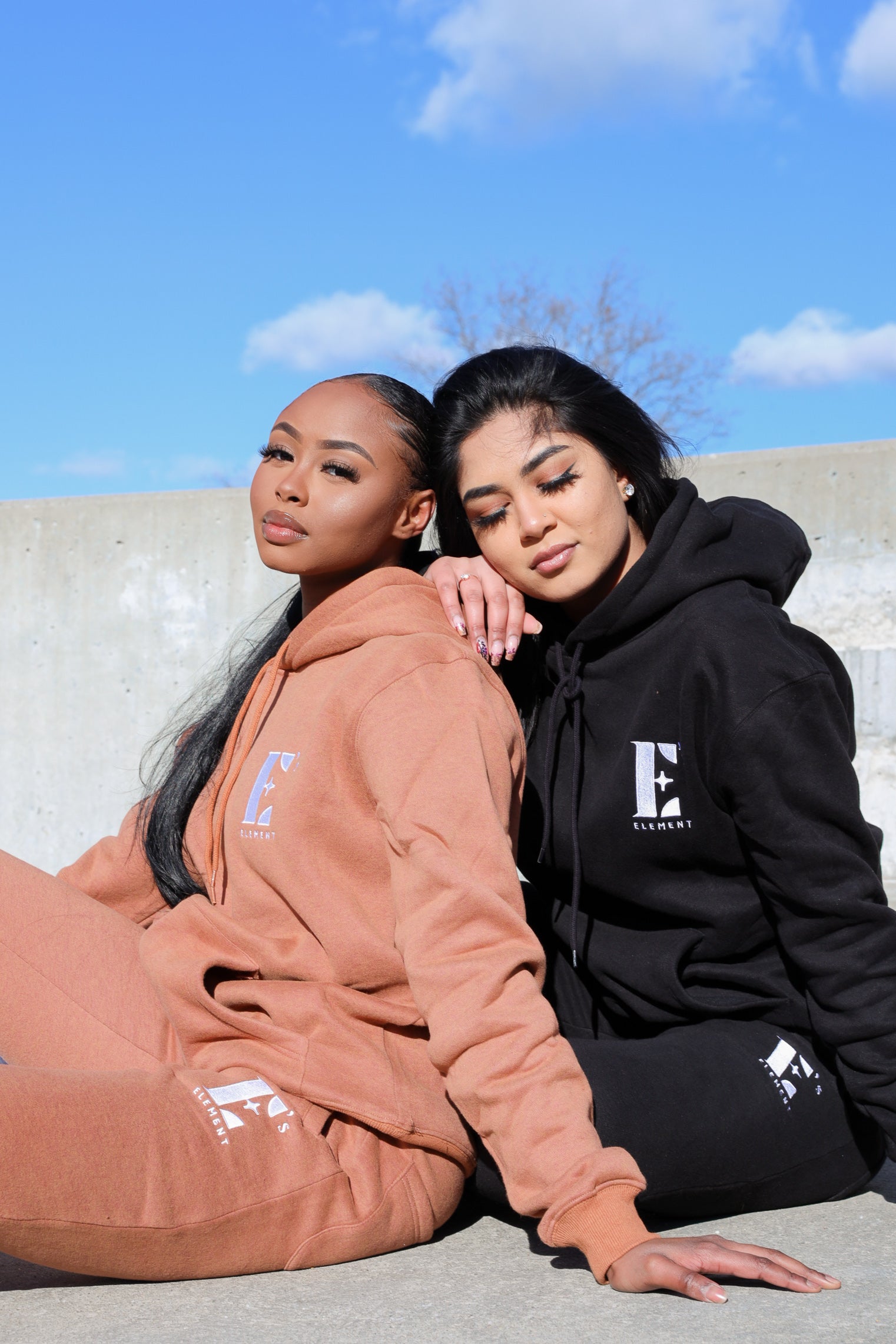 2 models in E's Element's Brown Sugar and Smoky Black sweat suit sets