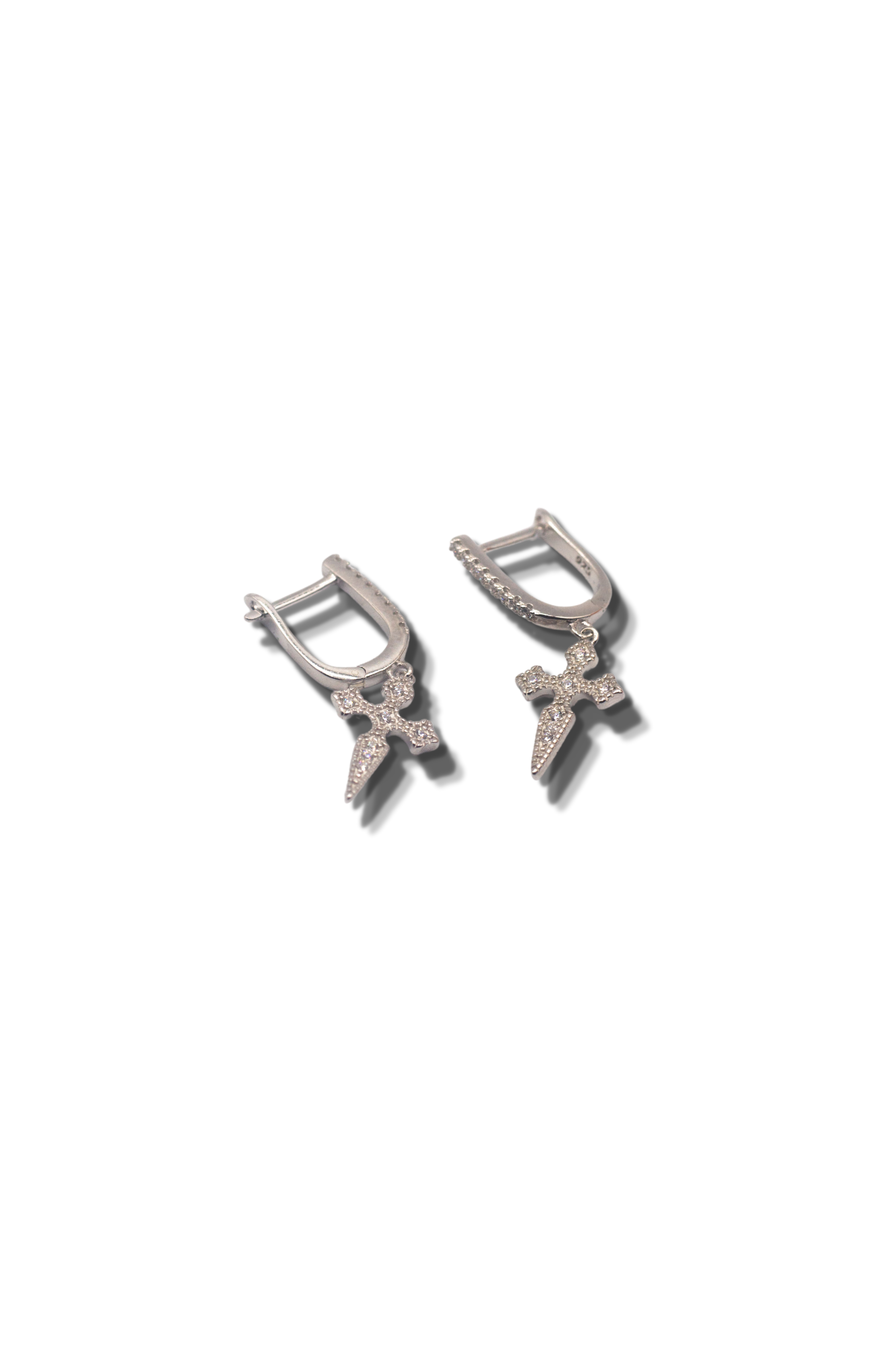 18k silver stainless steel earrings. The earrings have cross charms attached. Cross Cubic Zirconia Huggies by E's Element.