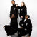 Models wearing black sweatsuits. The sweatsuits are imprinted with the E's Element logo in white. The models are also wearing matching white sneakers.E's Element Essential Smoky Black Sweatsuit Set by E's Element.