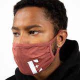 Model in a black hoodie wearing light brown reusable face mask. The face mask has the E's Element logo imprinted in white. Spice Face Mask by E's Element.