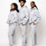 Photos of a male model and two female Model wearing the e's element essential sweatsuit in light grey. in this photo they all show the full outfit with the e's element logo showing on the hoodie and sweatpants. 