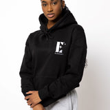 Model wearing a black hoodie. The hoodie has the E's Element logo imprinted in white. E's Element Essential Smoky Black Sweatsuit Set by E's Element.