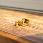Two 18k gold molten rings placed on the edge of a window. Ella Lava Ring 2.0 by E's Element.