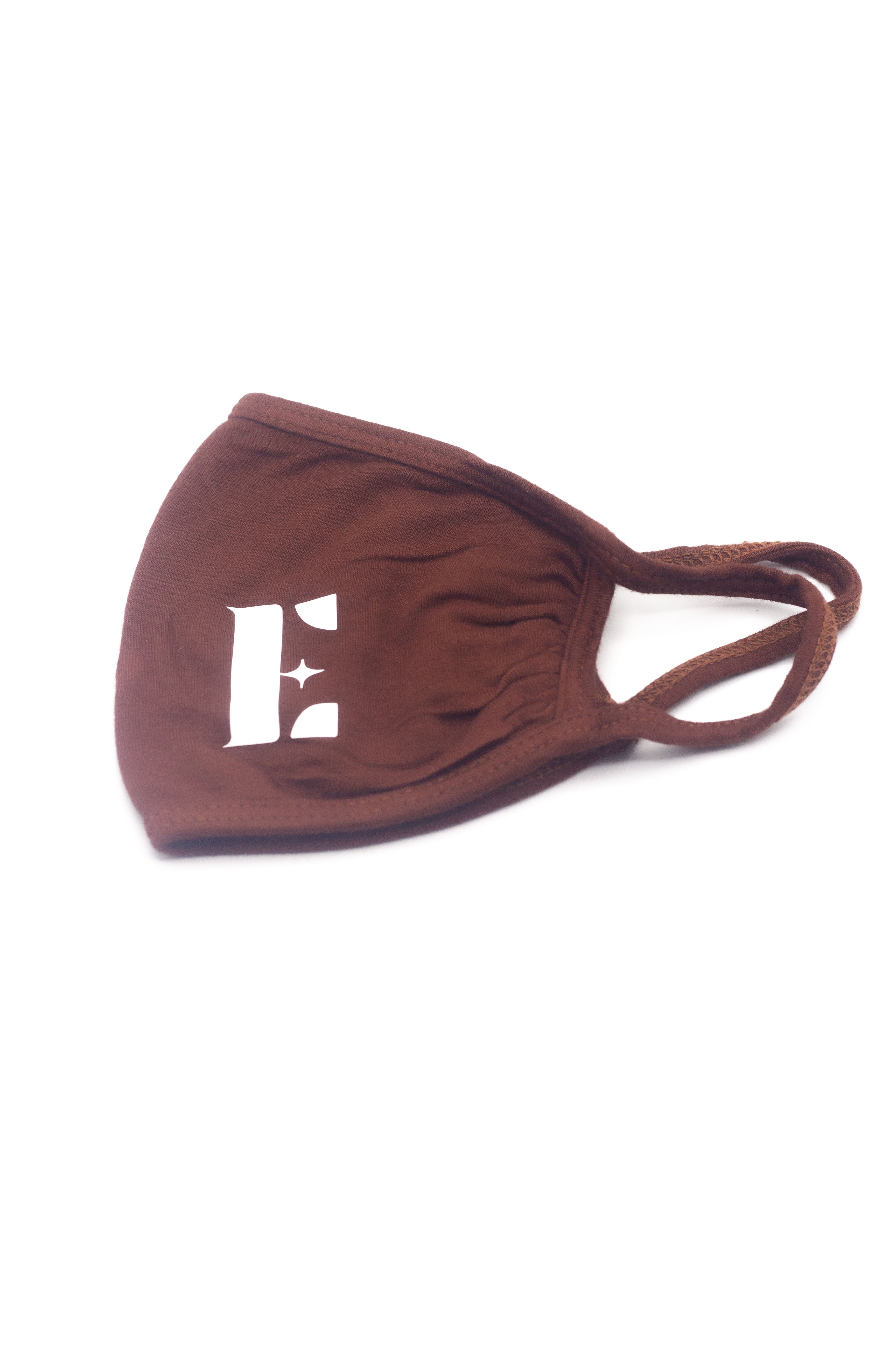 Dark orange reusable face mask. The face mask has the E's Element logo imprinted on the bottom left of it. Cinnamon Face Mask by E's Element.