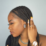 Woman in black top wearing silver stainless steel hoop earrings and chain necklace. Chunky Croissant Hoops by E's Element.