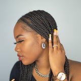 Woman in black top wearing silver stainless steel hoop earrings and chain necklace. Chunky Croissant Hoops by E's Element.