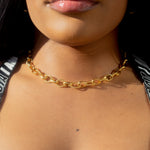 Model in a leopard top wearing 18k gold chain necklace with a rope pattern. Rope Link Signature Chain by E's Element.