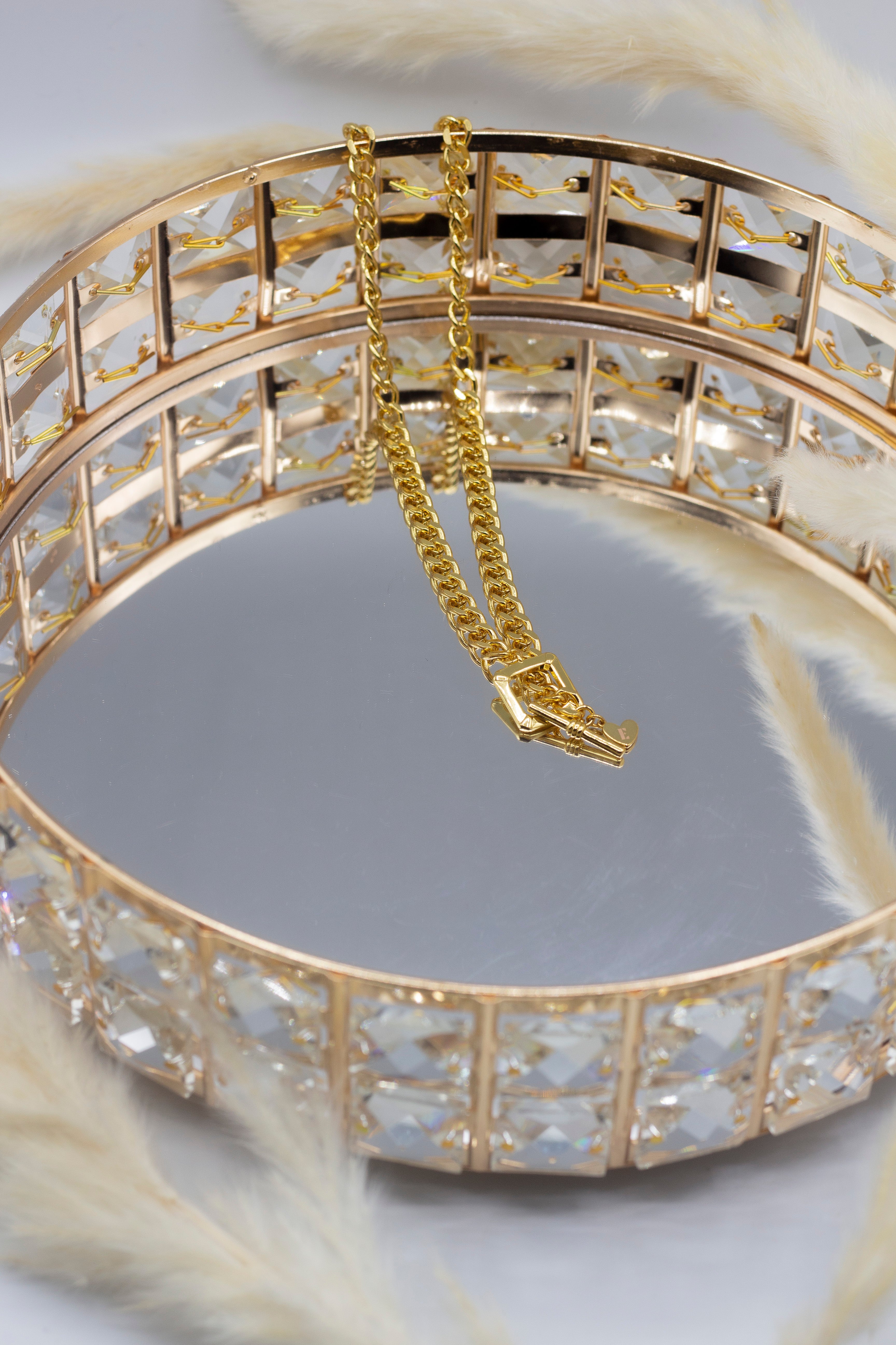 18k gold stainless steel buckle chain necklace placed on a mirror. Ella Buckle Chain by E's Element.