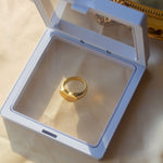 18k gold heart signet ring resting in a white container on a table with a beige cloth. Ellina Heart Signet Ring by E's Element.