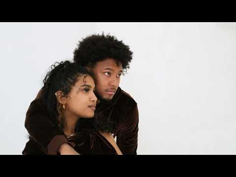 Video of male and female models wearing and posing with the e's element chocolate brown velvet crop top hoodie and jogger set. Also the model are wearing the E's element essential sweatsuit set in light grey.