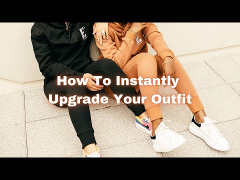 There are two models in this video. One of the models is wearing a light orange track suit and the other is wearing a black track suit. The hoodies and track pants have E's Element logo imprinted in white. 