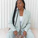 Woman in a mint green suit wearing "The Toyo" Twist Set by E's Element.