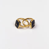 Two 18k gold rings. The rings have a zircon stone in the middle of a rectangular black surface. Infinity Zircon Ring by E's Element.