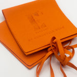 Two orange microfiber leather pouches. Microfiber Jewelry Pouch by E's Element.