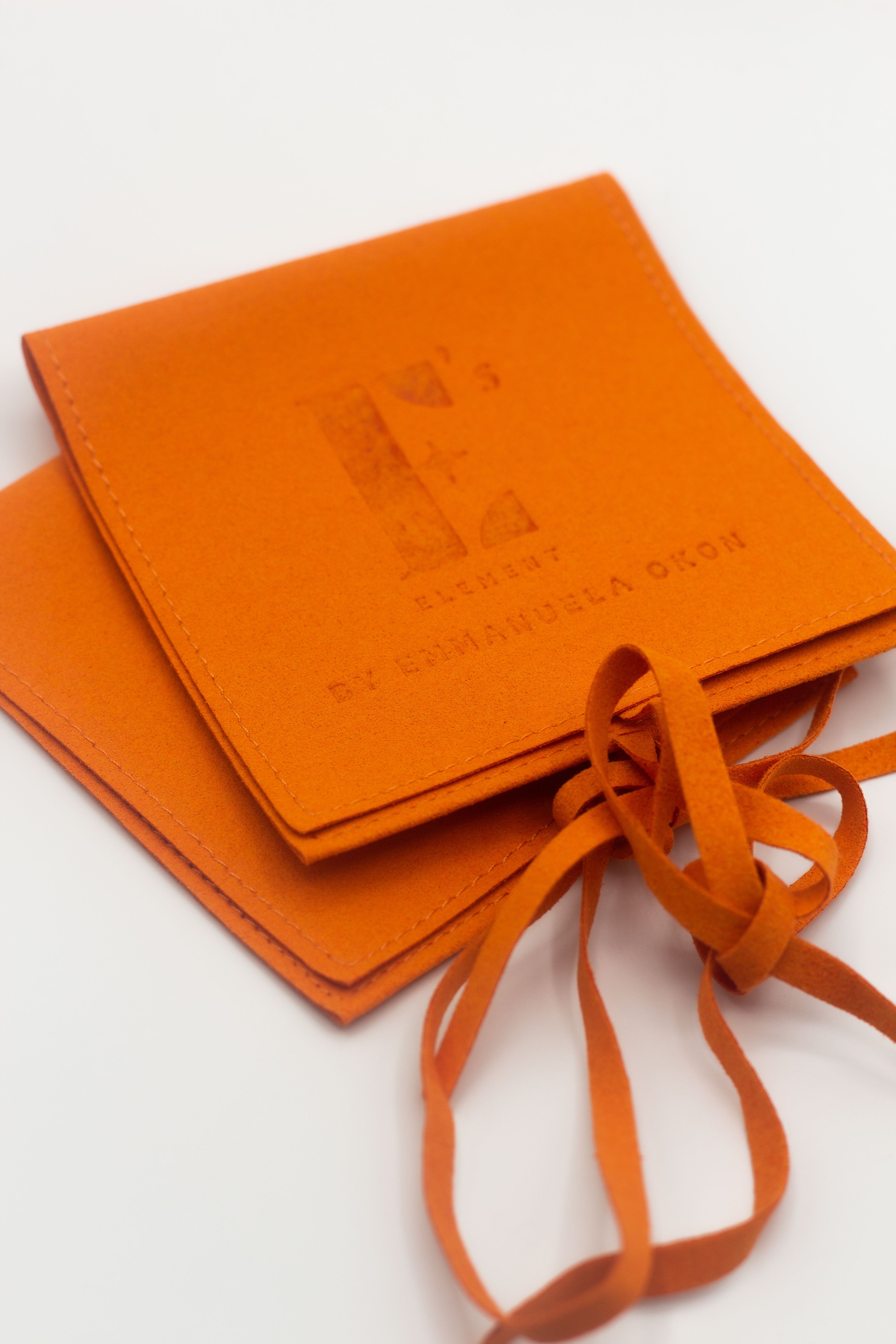 Two orange microfiber leather pouches. Microfiber Jewelry Pouch by E's Element.