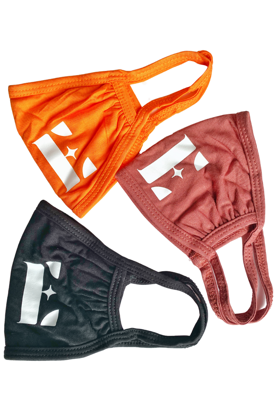 Three of E's Element reusable face masks. The colors are bright orange, light brown, and black. Burnt Orange Face Mask by E's Element.