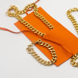 18k gold chain necklace resting inside an orange microfiber leather pouch. On the left is a gold chain bracelet and on the right is another gold chain necklace.  Microfiber Jewelry Pouch by E's Element